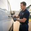 Van security installer checking an additional lock on a modern white van