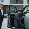 Installer and UK vehicle owner discussing tracker insurance discount checks